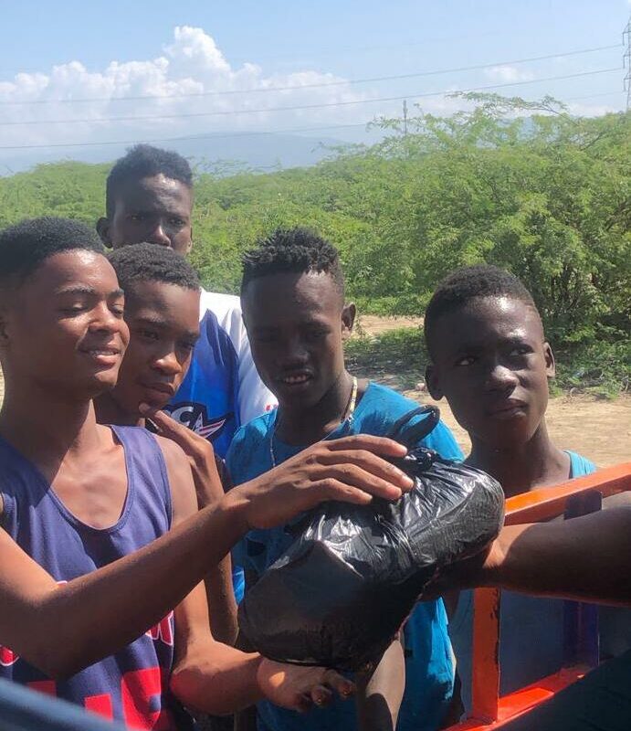 Haitians receiving a food kit from Chanje Movement