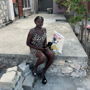 young haitian woman with food for her community